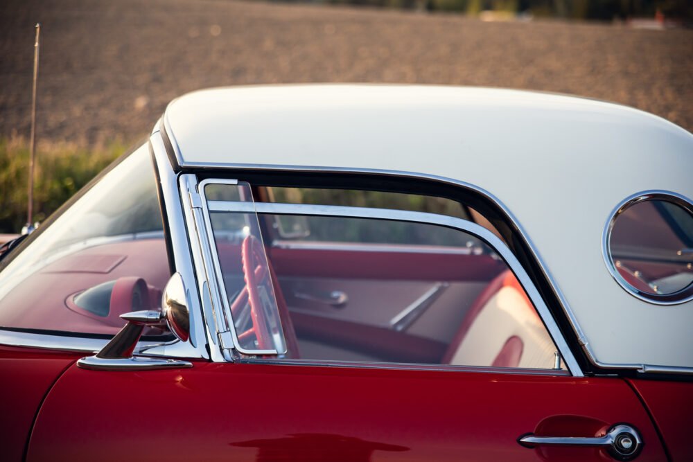 Vintage red car with white roof close-up.