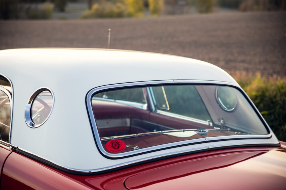 Vintage red and white car rear window details.