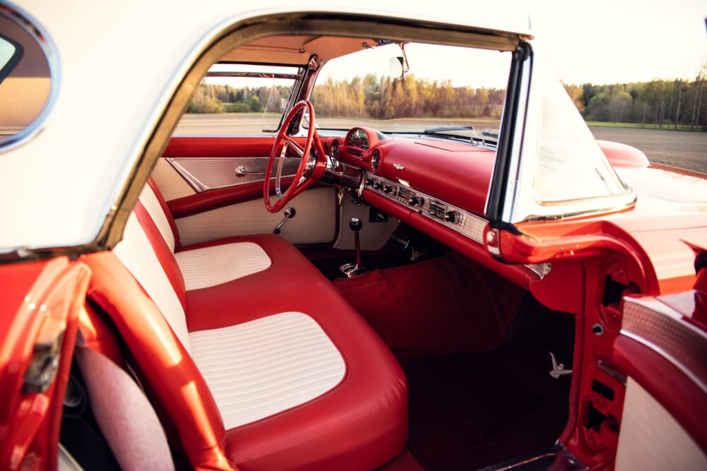 Vintage red convertible car interior, classic design.