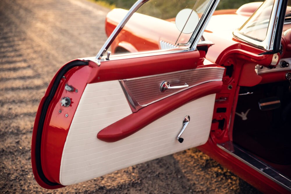 Vintage red car with open door detail.