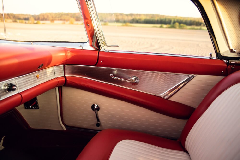 Classic car interior with red and white upholstery.