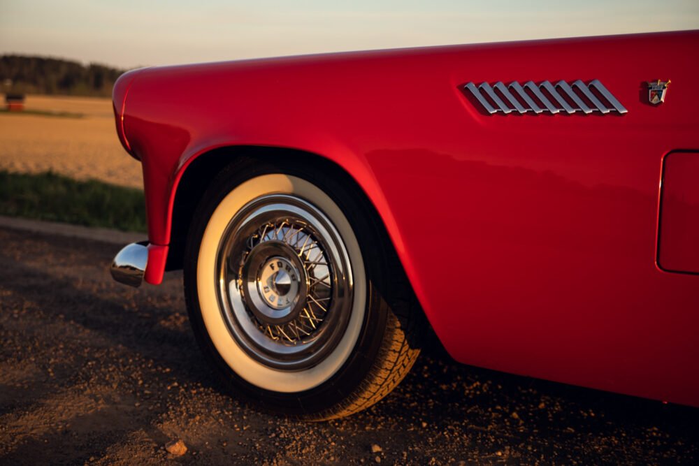 Red vintage car detail at sunset.