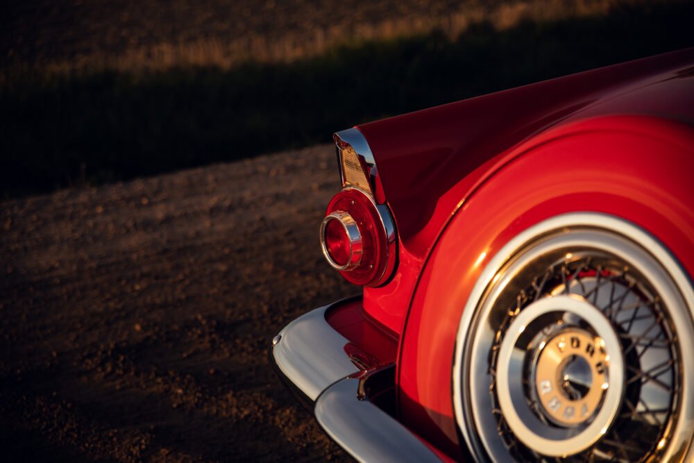 Red vintage car tailfin at sunset.