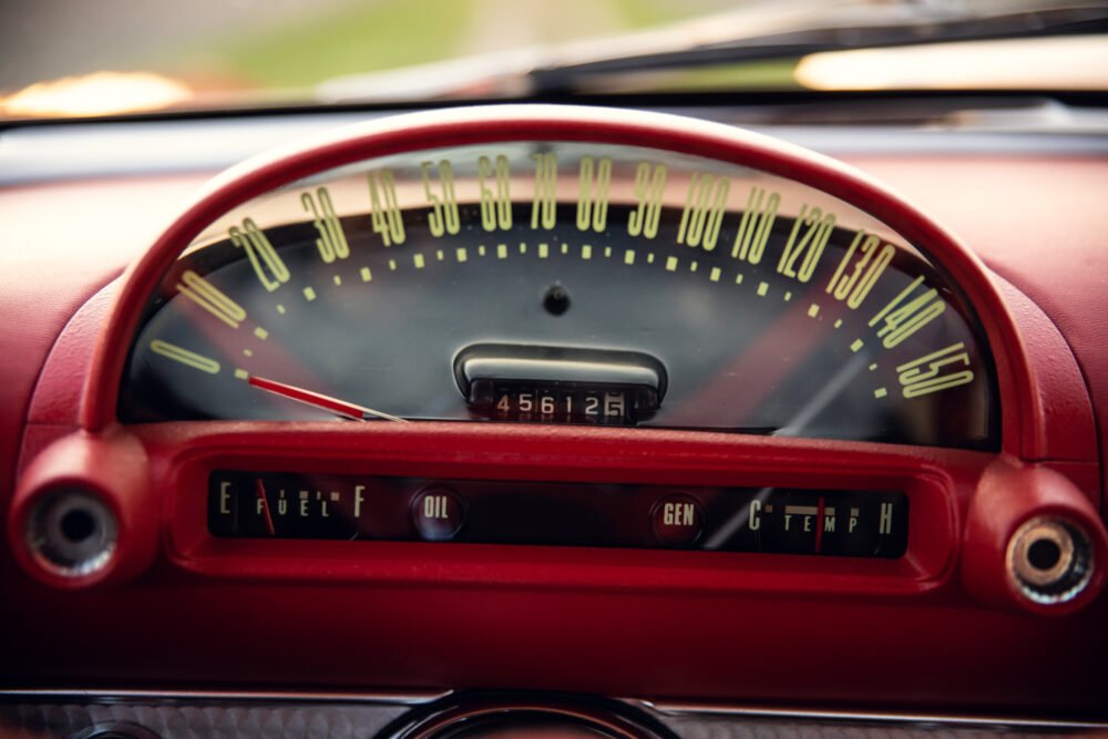 Vintage car speedometer and dashboard gauges close-up.