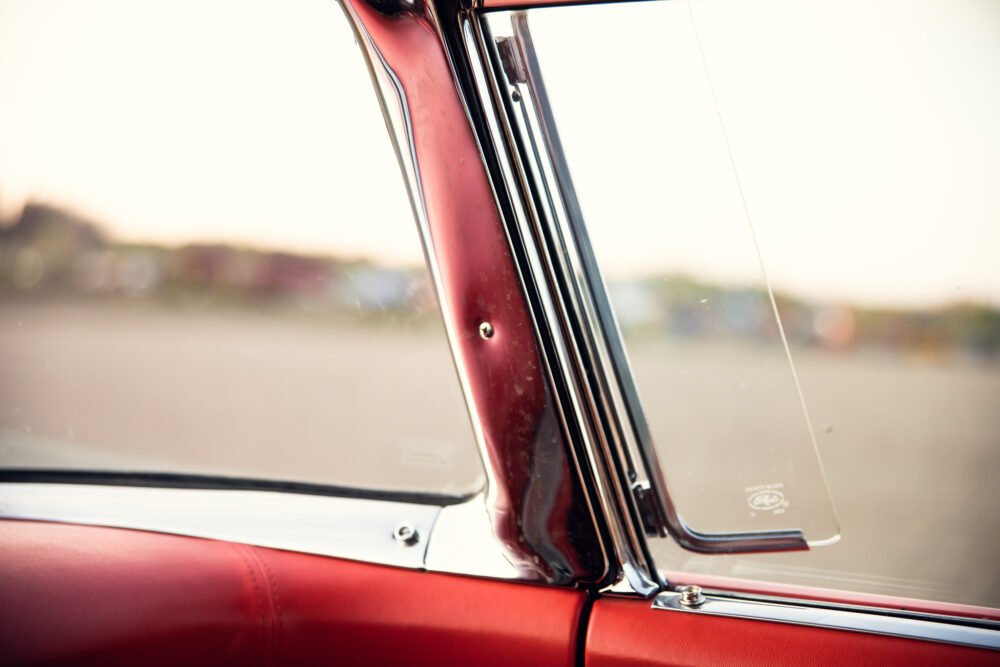 Close-up of vintage car door and window.