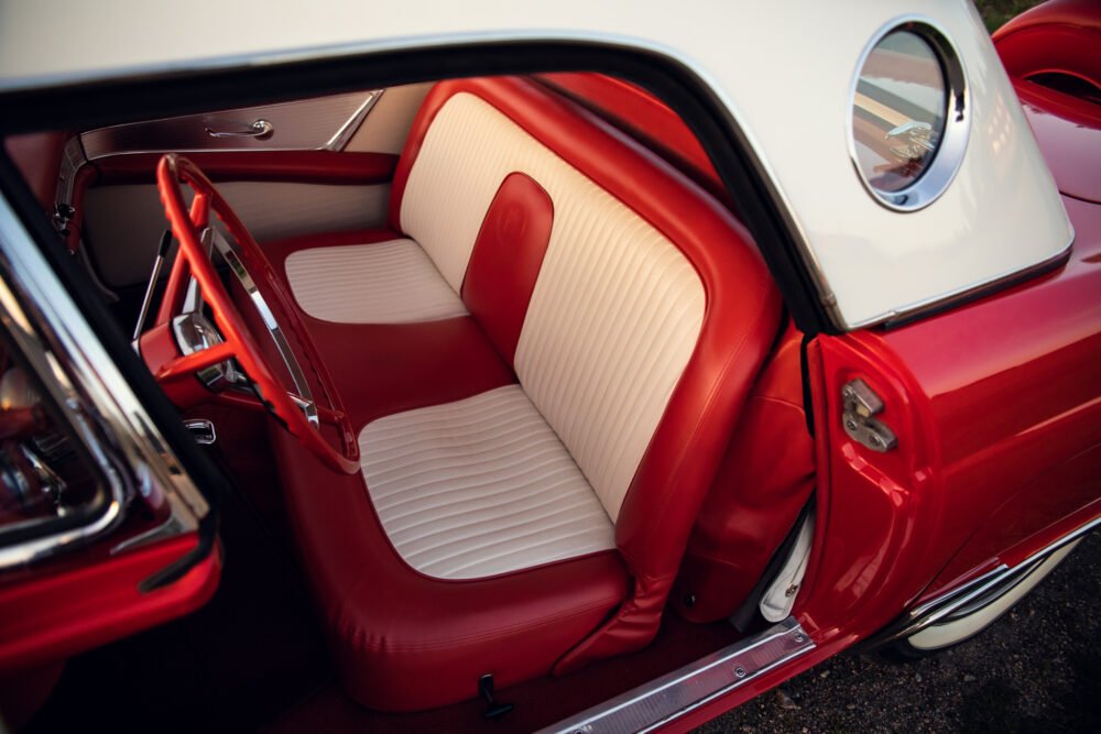 Vintage car with elegant red and white interior.