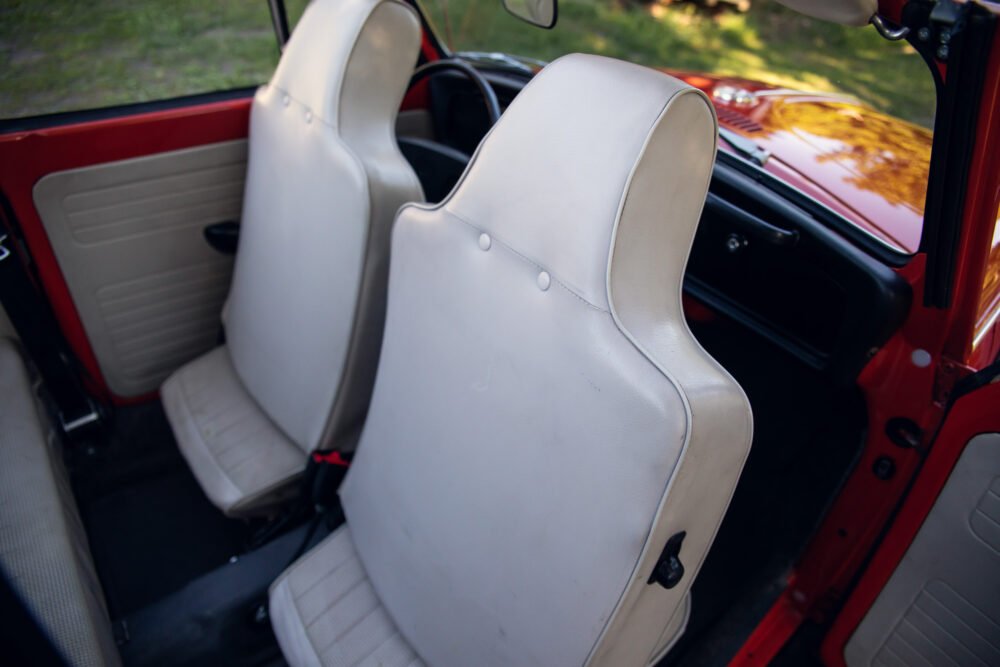Red convertible's white leather interior detail.