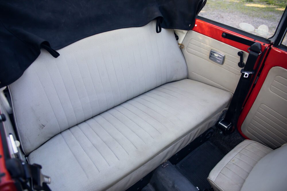 Vintage car's white interior backseat view.