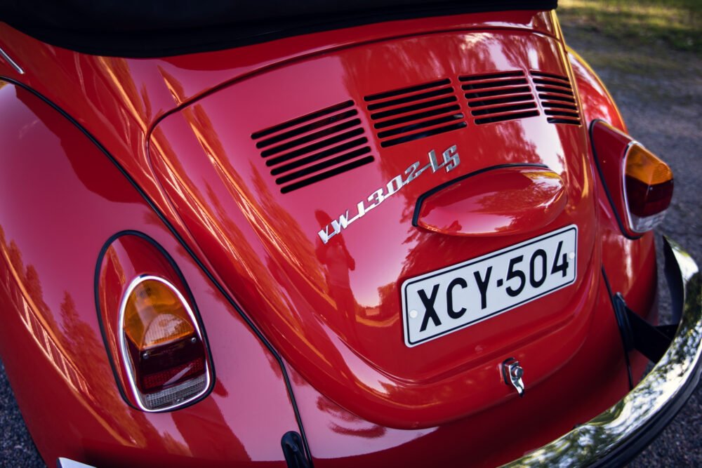 Close-up of red vintage Volkswagen Beetle's rear end.