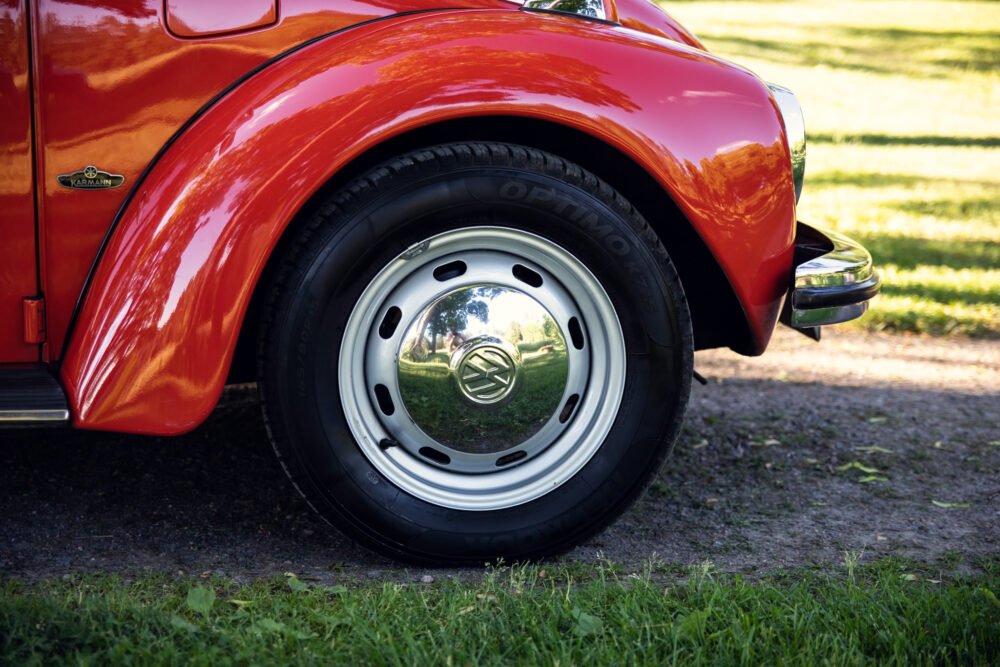 Red vintage car wheel and fender detail.