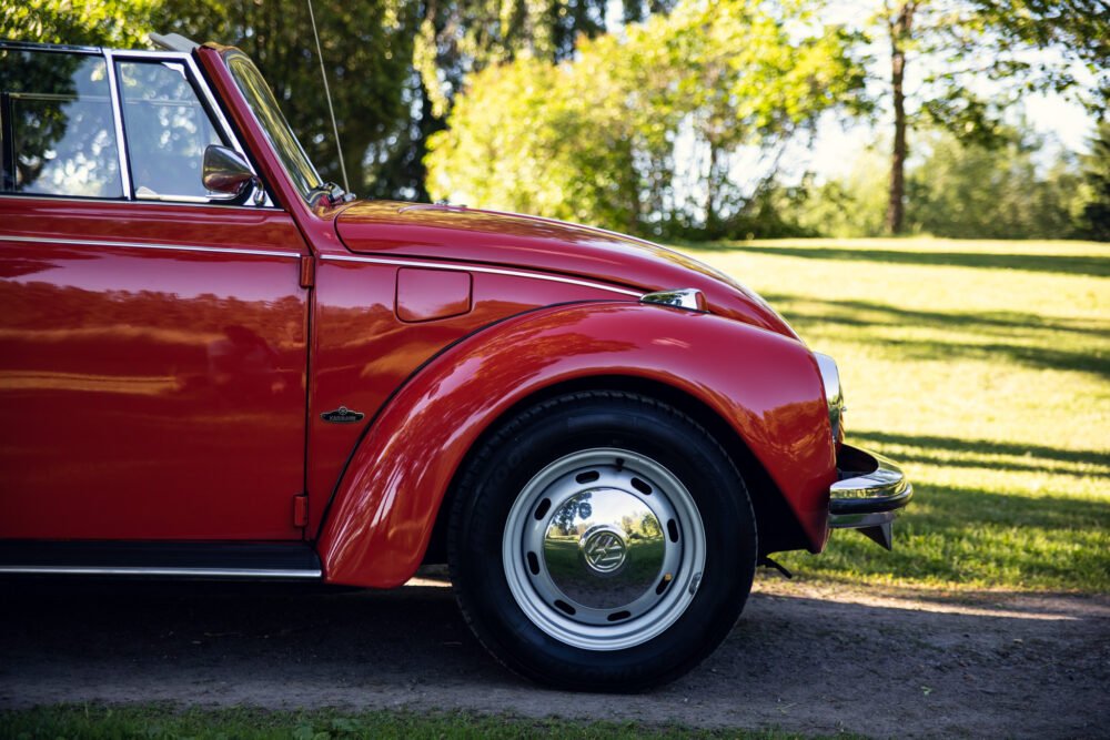 Red vintage Volkswagen Beetle parked outdoors