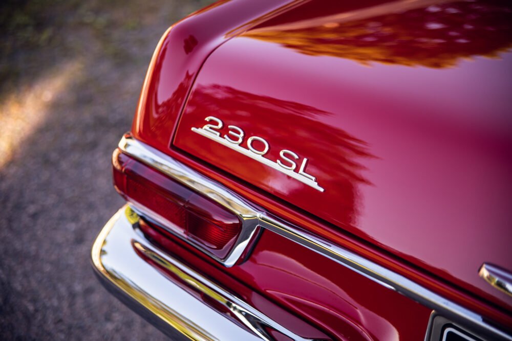 Red 230SL vintage car close-up detail.