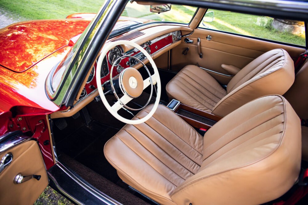 Vintage red convertible, luxury interior view.