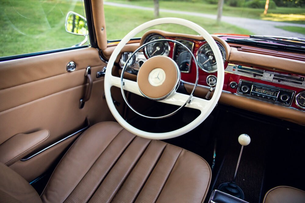 Vintage Mercedes interior with elegant dashboard and steering wheel.
