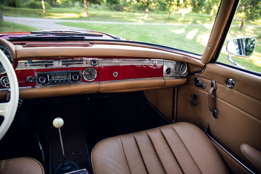 Vintage car interior showing dashboard and leather seats.