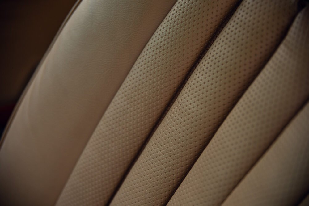 Close-up of textured beige leather upholstery.