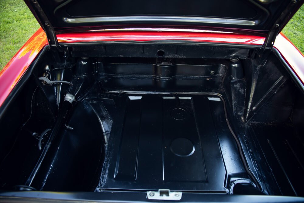 Open trunk of vintage car showing clean interior.