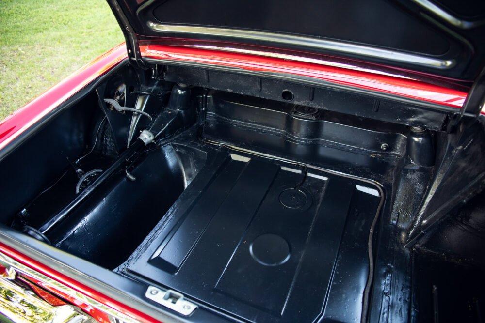 Open trunk of a vintage red car.