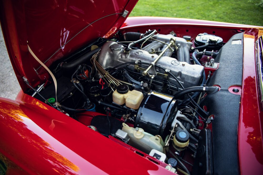 Classic car engine bay, red vintage vehicle.