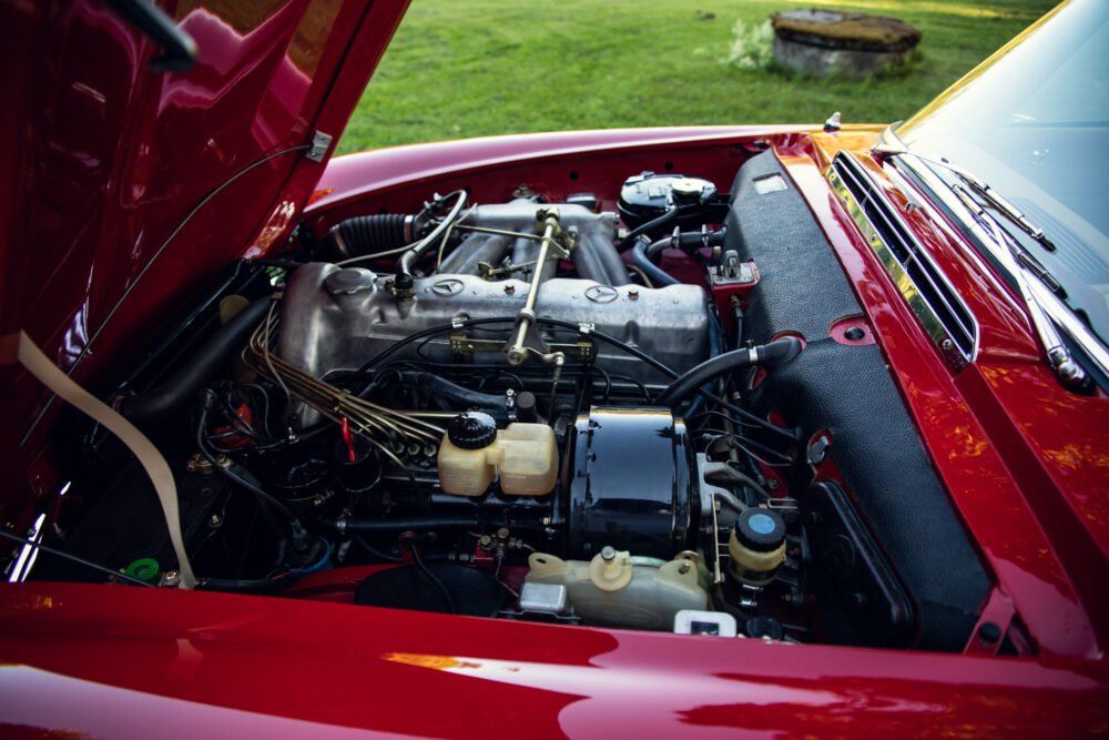 Red classic car engine close-up.