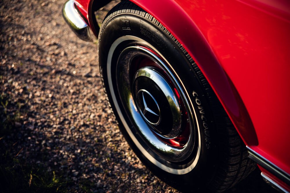 Red vintage car wheel close-up.