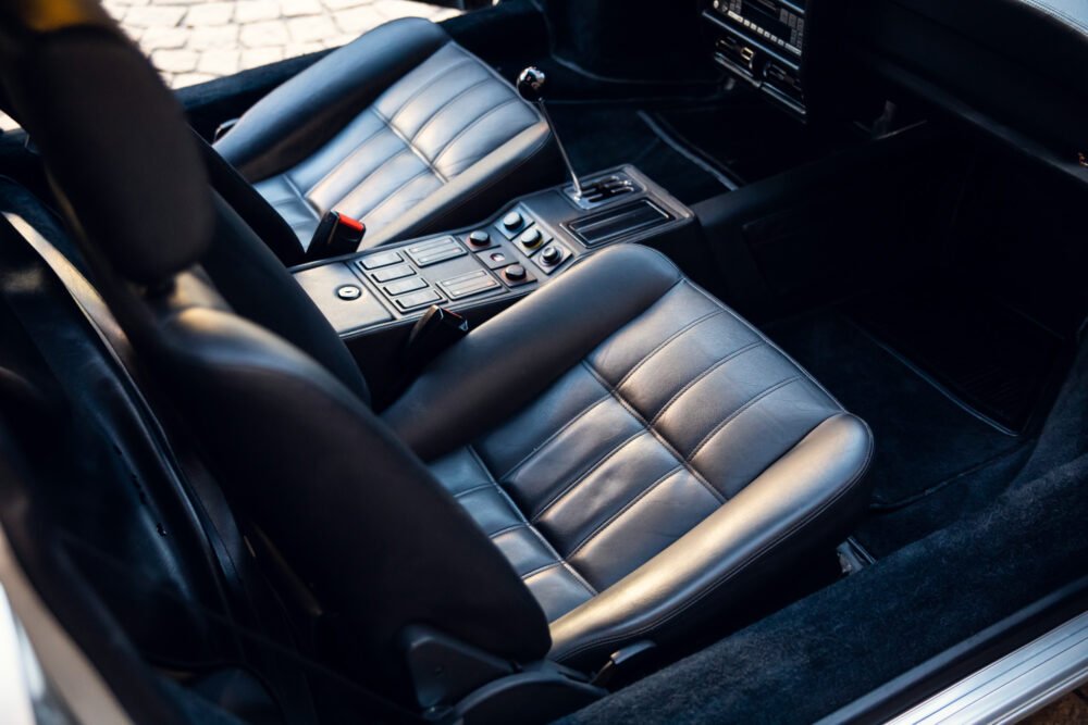 Luxury car interior with leather seats and center console.