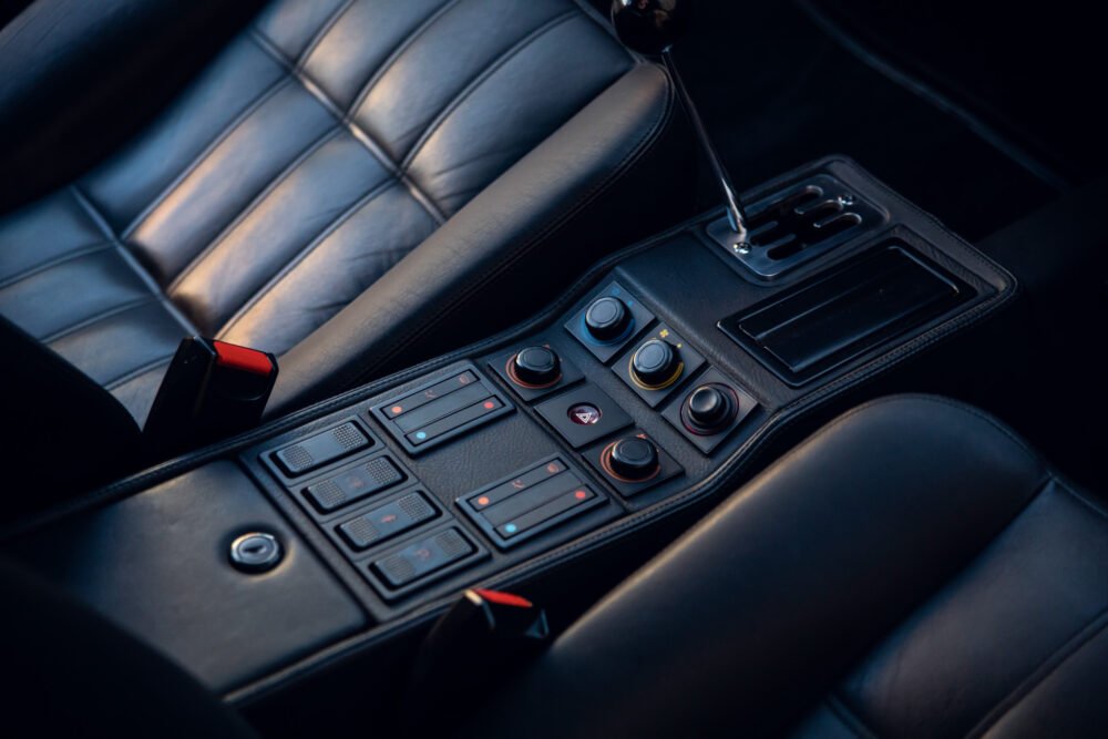 Luxury car interior with gear shift and controls.