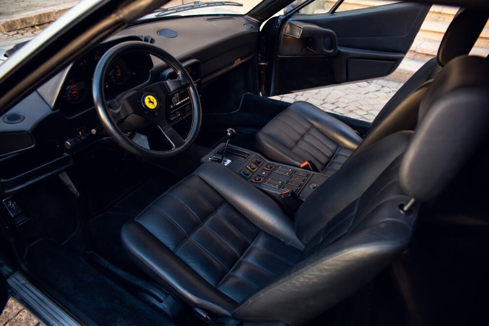 Interior view of a luxury sports car with leather seats.