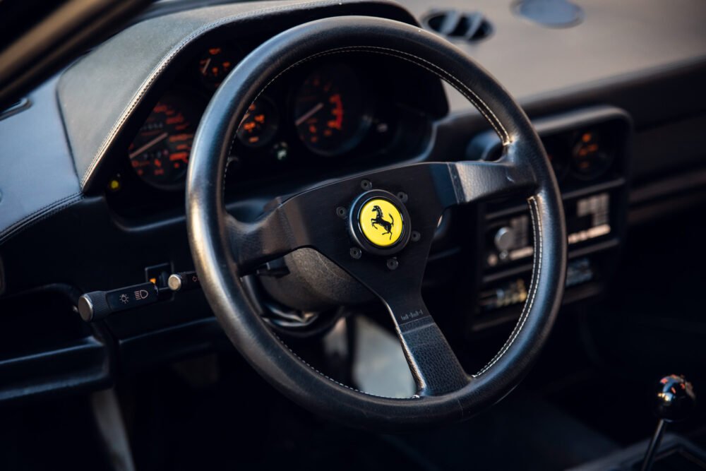 Ferrari steering wheel, dashboard, and interior details.