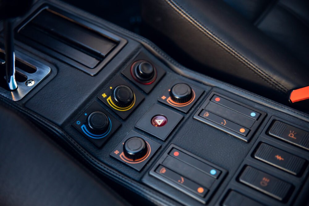 Car's center console with various control buttons and knobs.