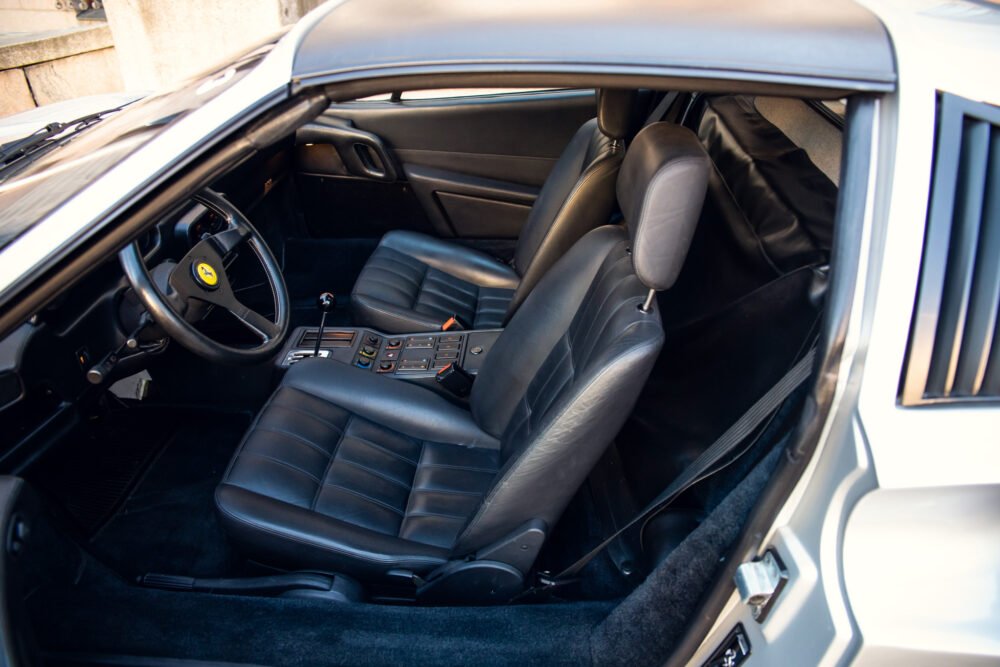 Interior view of classic Ferrari with leather seats.