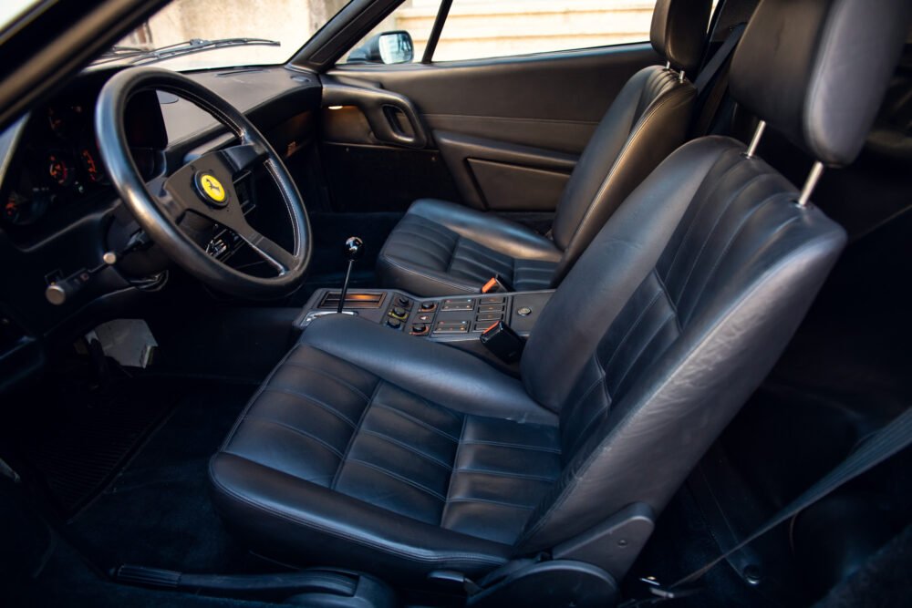Luxury car interior with leather seats and sporty dashboard.