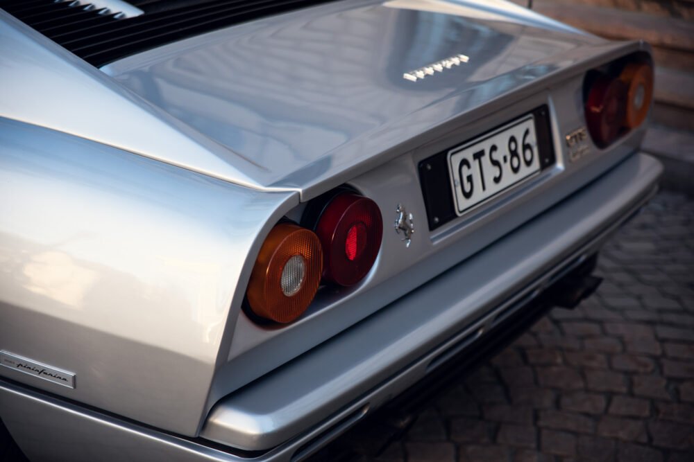 Close-up of silver vintage sports car rear design.