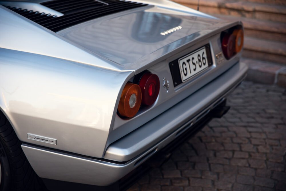 Rear view of classic white sports car, license plate GTS86.