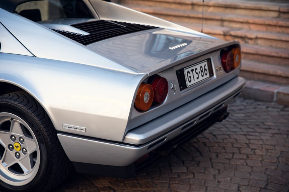 Silver Ferrari with distinctive tail lights and logo.