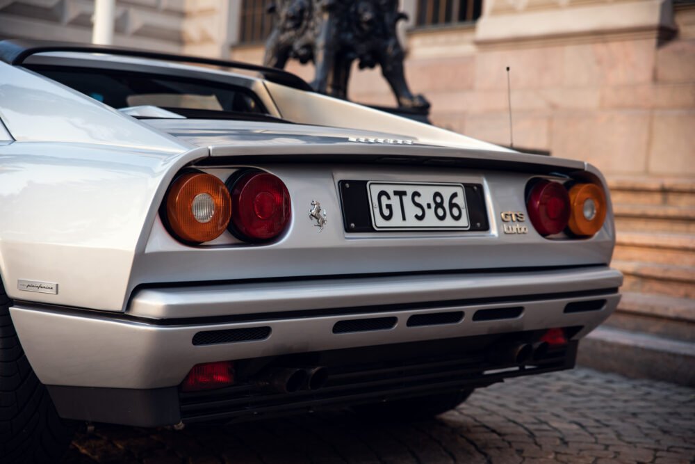 Rear view of white vintage Ferrari, license GTS-86.