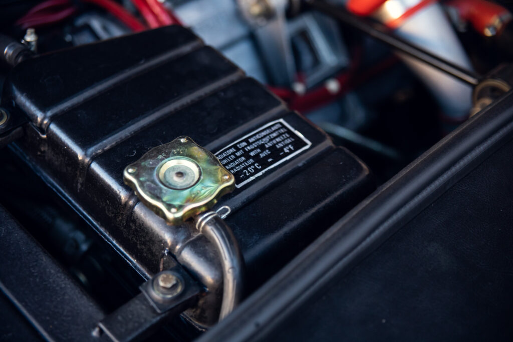 Close-up of car engine coolant reservoir cap.
