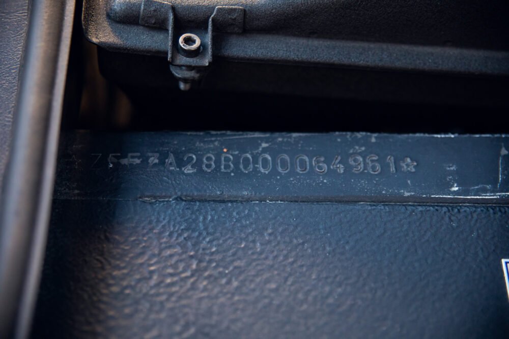 Close-up of vehicle identification number (VIN) on car.