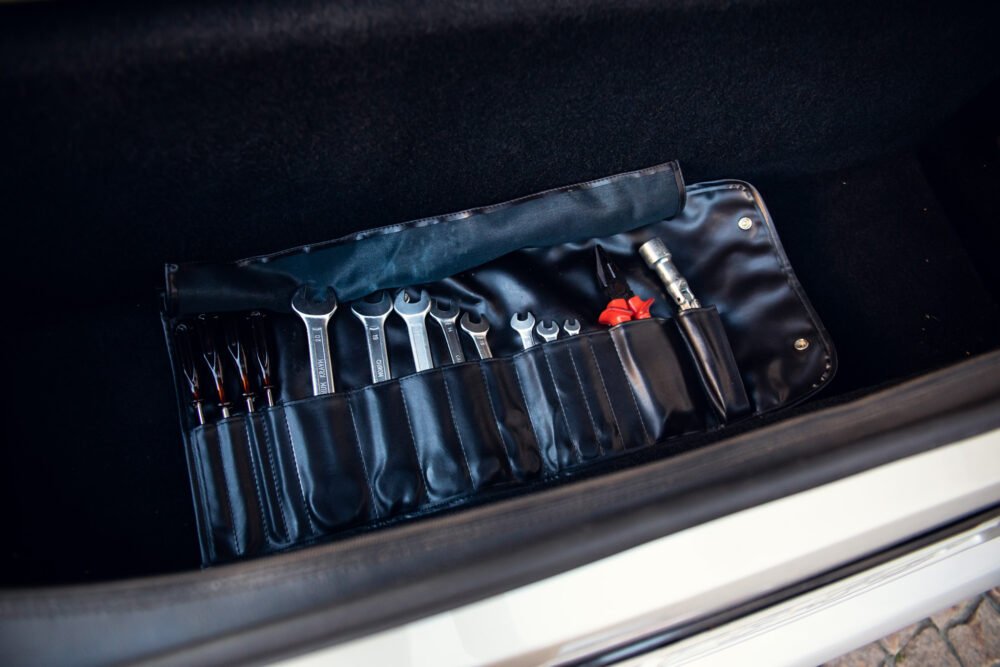 Tool set in car trunk for emergency repairs.