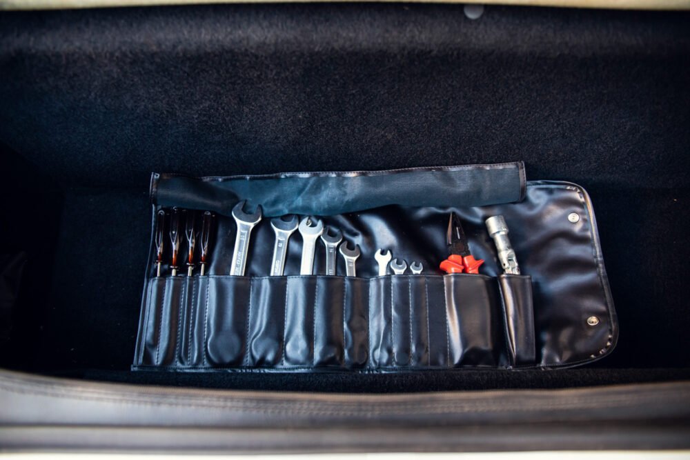 Tool kit stored in car trunk.