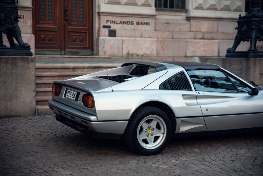 White vintage Ferrari parked outside Finland's Bank building.
