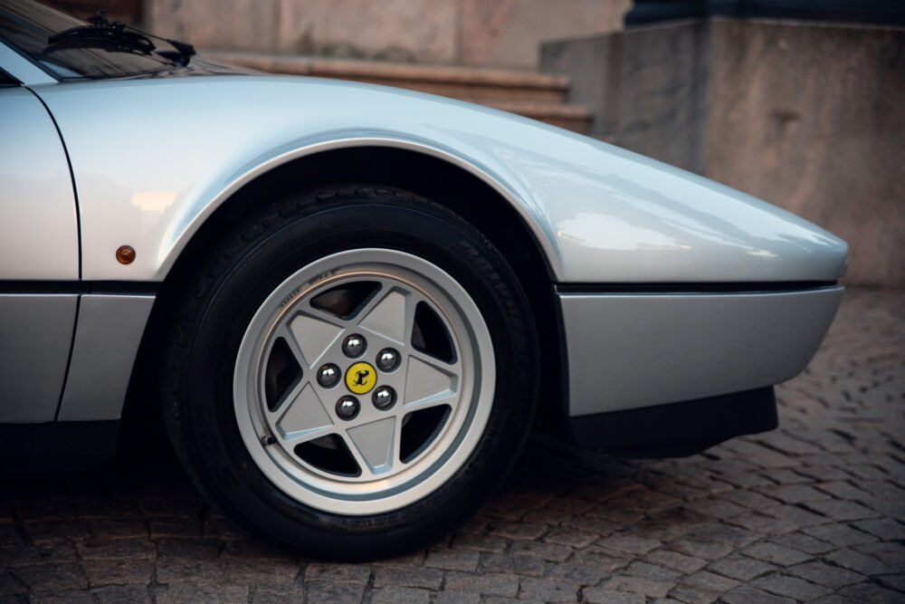 Classic car wheel with emblem, close-up.