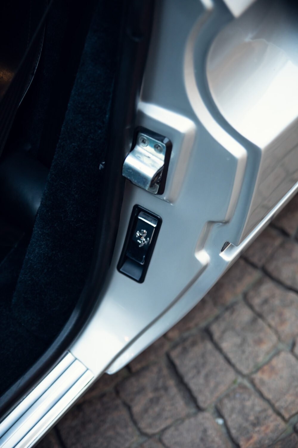 Close-up of car door latch system.