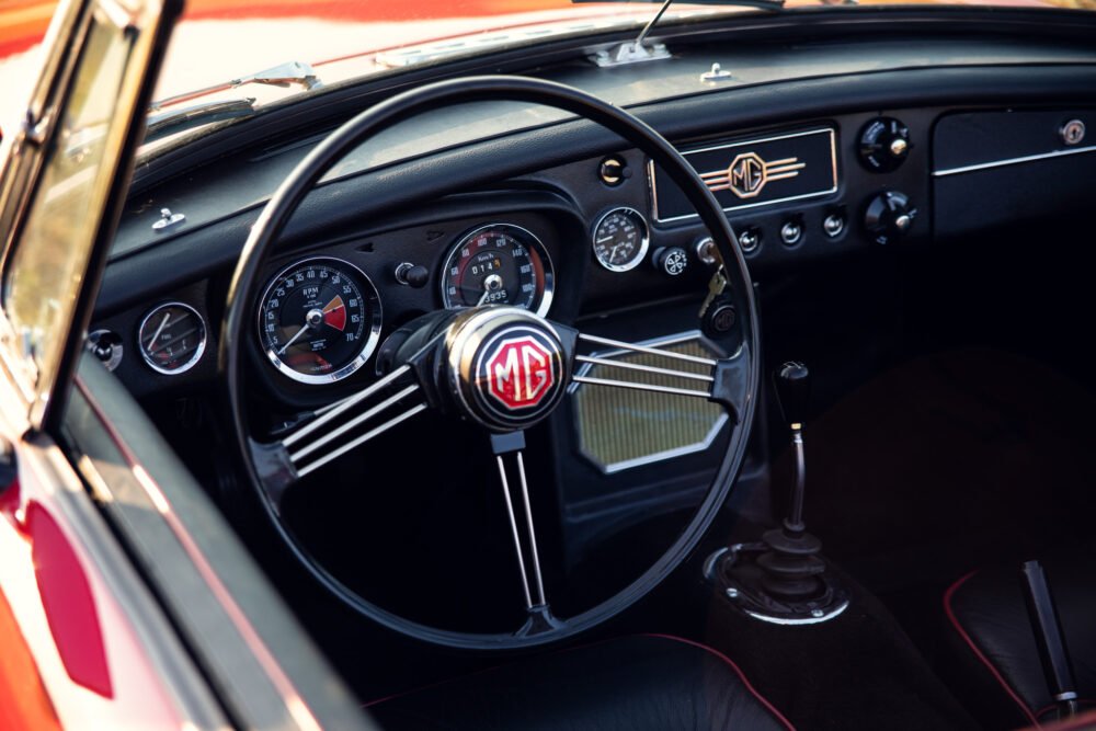 Vintage MG car interior, classic dashboard and steering wheel.