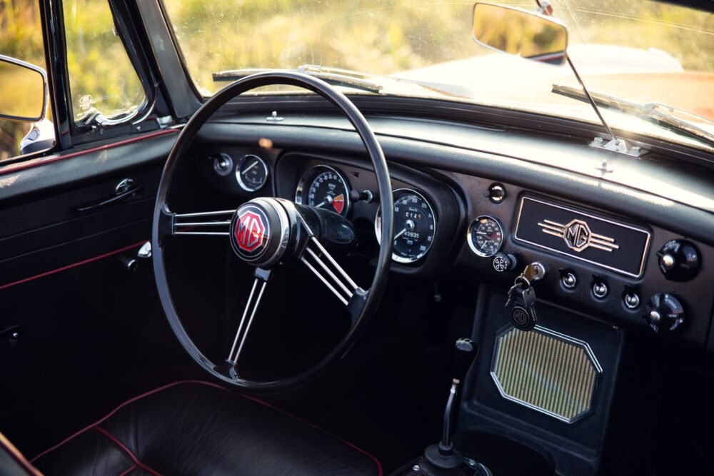 Vintage MG car dashboard and steering wheel detail.