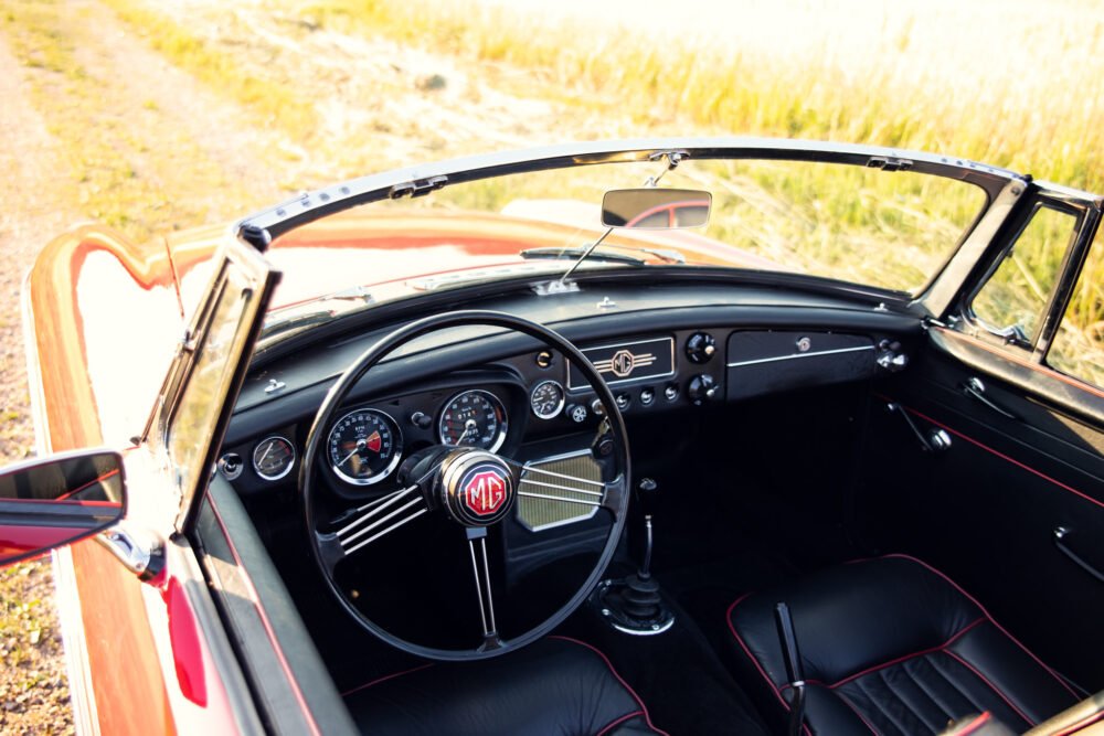 Vintage MG convertible car interior with open dashboard.