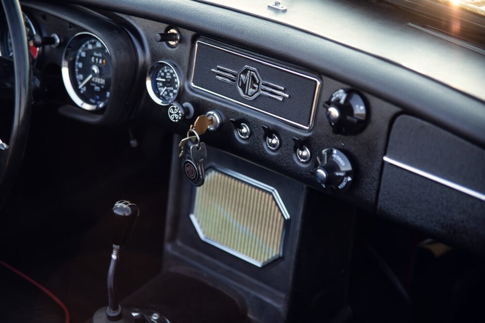 Vintage MG car dashboard with logo and keys.