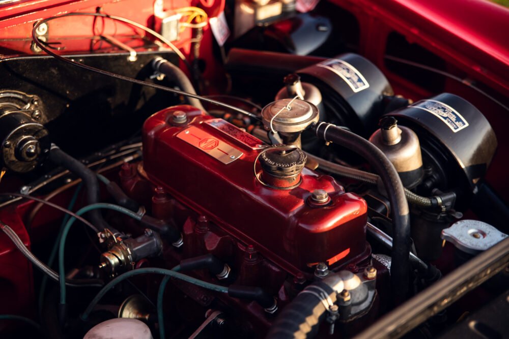 Vintage red car engine in close-up detail.