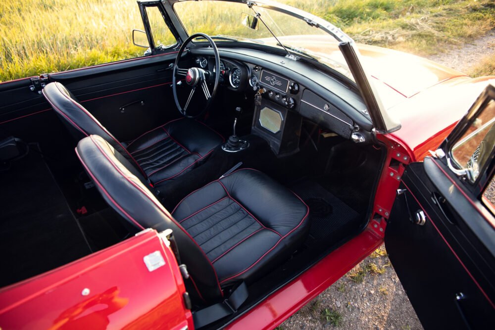 Vintage red convertible interior with leather seats.