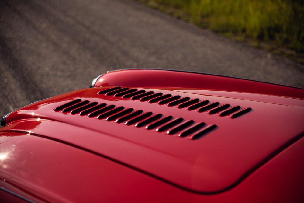 Close-up of red car's hood with air vents